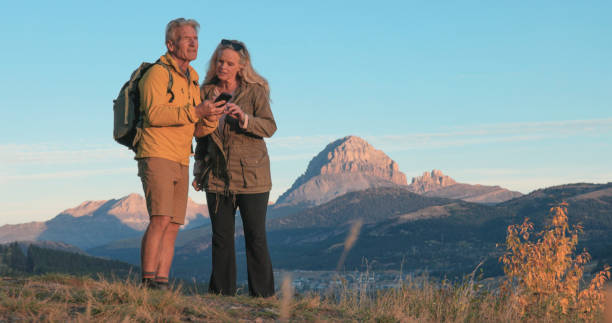 istock Mature couple use mobile phone on hike 2177679784