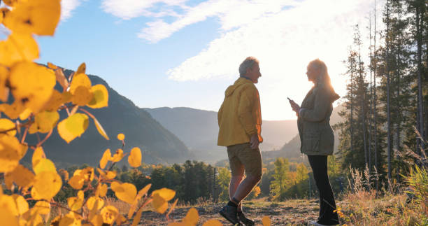 istock Mature couple use mobile phone on hike 2177679794