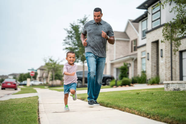 istock Joyful Diverse Father and Child Enjoying a Run Outdoors 2177681129