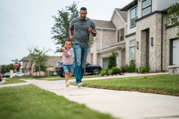 istock Father and Son Enjoying a Run in a Suburban Setting 2177681134