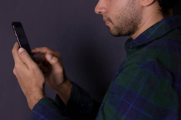 istock Man in blue shirt typing on cell phone 2177682128