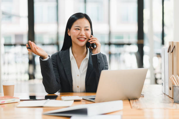 istock Efficient businesswoman on phone, smiling and engaged in conversation 2177684009