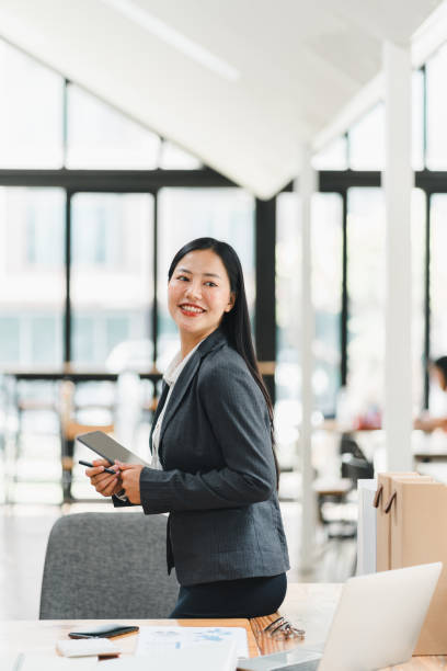 istock A professional woman smiles confidently in modern office setting. 2177684047
