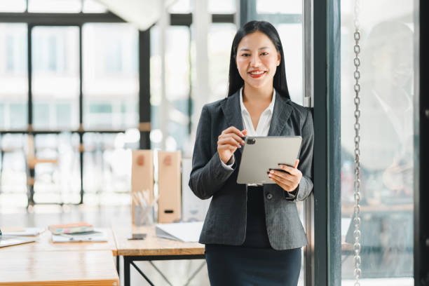 istock A confident businesswoman using tablet in modern office setting. 2177684147