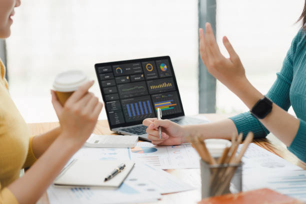 istock Two woman working on financial analysis with charts and laptop. 2177684420