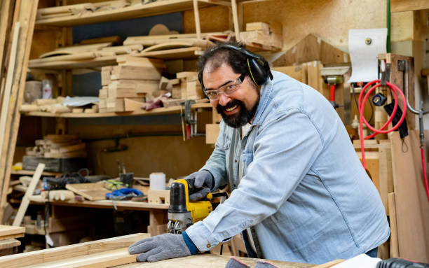 istock Carpenter cutting wood using an electric saw at his workshop 2177689433
