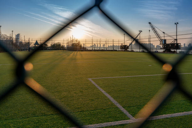 Digital composition of soccer field and blue sky