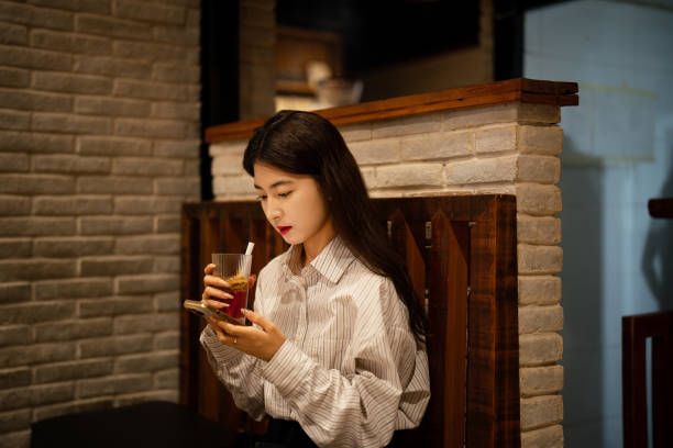 istock Young beautiful woman using smartphone in old coffee shop 2177698148