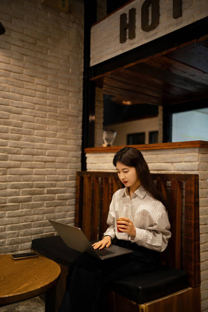 istock Young beautiful woman using laptop in old coffee shop 2177698200