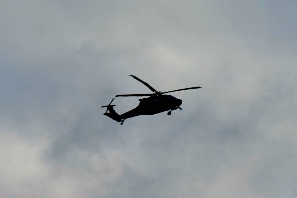 istock Army Helicopter Silhoutted Against Sky 2177707381