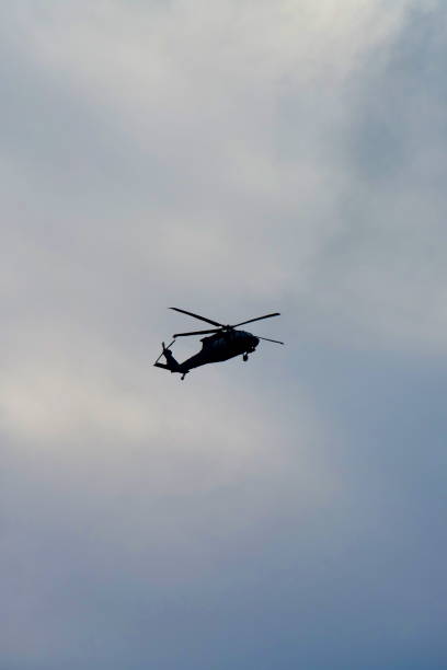istock Army Helicopter Silhoutted Against Sky 2177707391