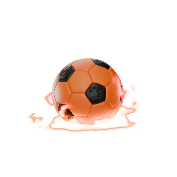 Midsection of soccer ball lying on soccer field lawn while player is stretching in background during daytime