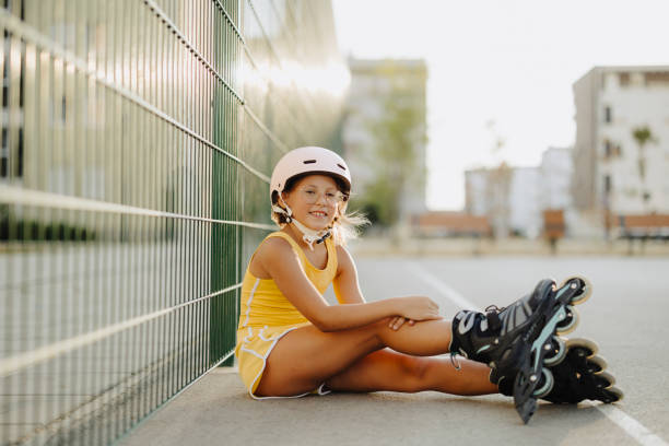 Roller blades. Roller skating girl kid in park rollerblading on inline skates