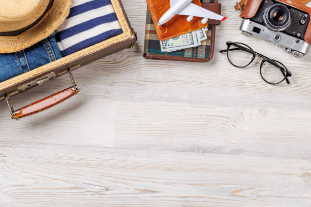 istock A travel bag with clothes, sun hat, flip flops, and a camera 2177711670