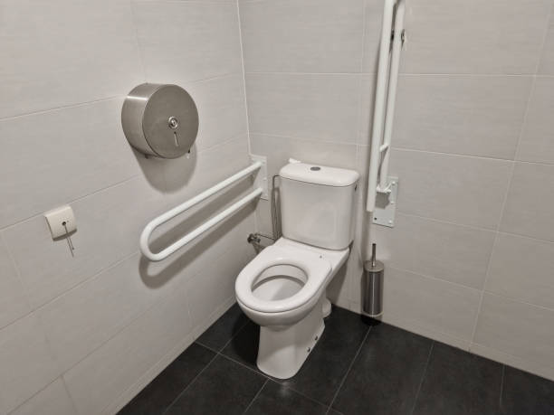 istock toilets for wheelchair users and disabled people have a tilting mirror that points to the ground because the height of the person sitting is lower. lever taps for easier water temperature adjustment 2177713339