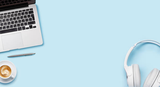 istock Laptop, headphones, and coffee cup arranged on a blue background 2177714307