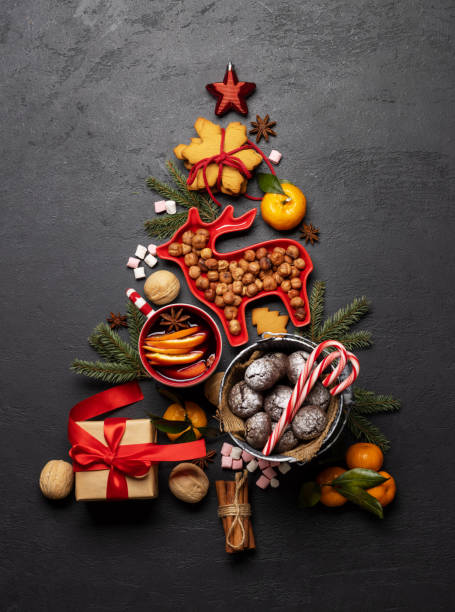 istock Christmas tree-shaped with cookies, surrounded by assorted nuts and festive decor 2177714533