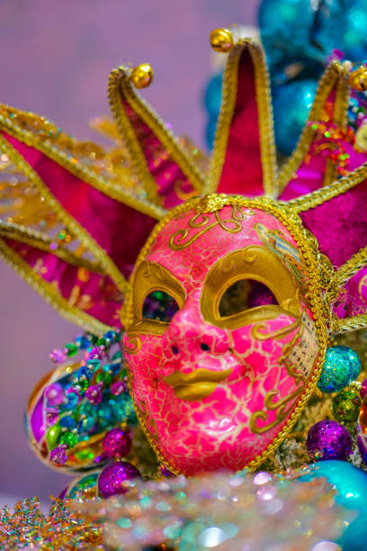 istock Carnival bright mask on a purple background.Carnival background with masks, feathers and glitter. 2177715087