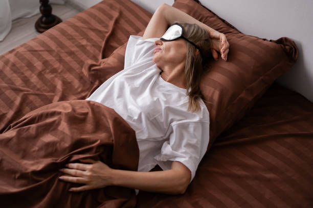 istock Middle aged woman with blindfold sleeping in her comfortable bed in bedroom 2177715372