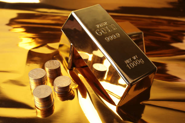 istock Gold bars with coins on a golden background 2177716122