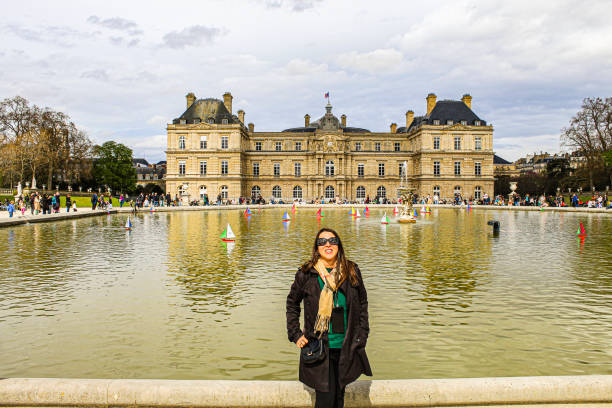 Image of a woman in front of the Palais du Luxembourg in Paris