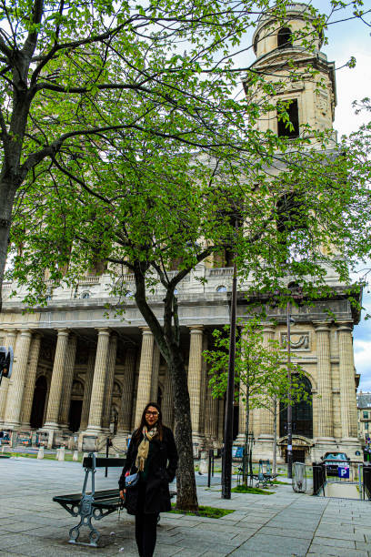 Image of a woman in front of Saint Sulpice church in Paris