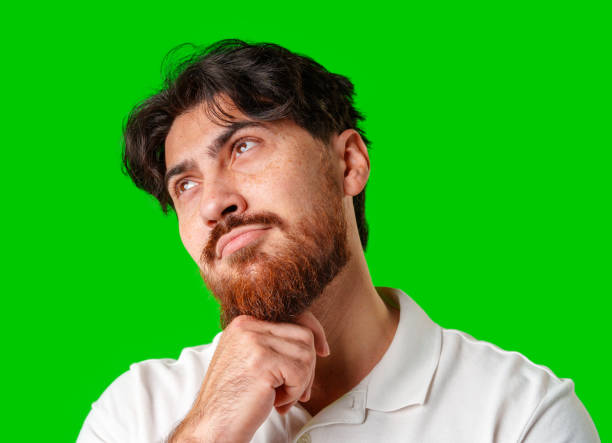istock A man contemplates thoughtfully against a bright green background 2177717200