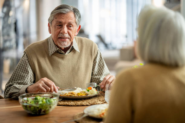 istock Senior Couple Enjoys Homely Meal 2177719041