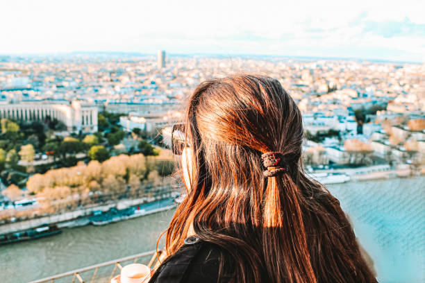 Image of a woman enjoying Paris from the Tour Eiffel