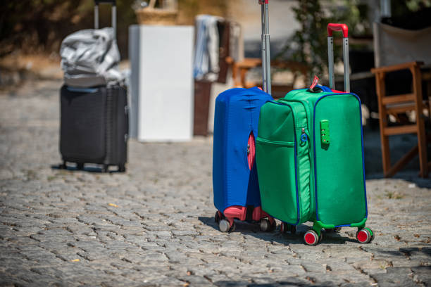 A blue and green suitcase placed on the ground
