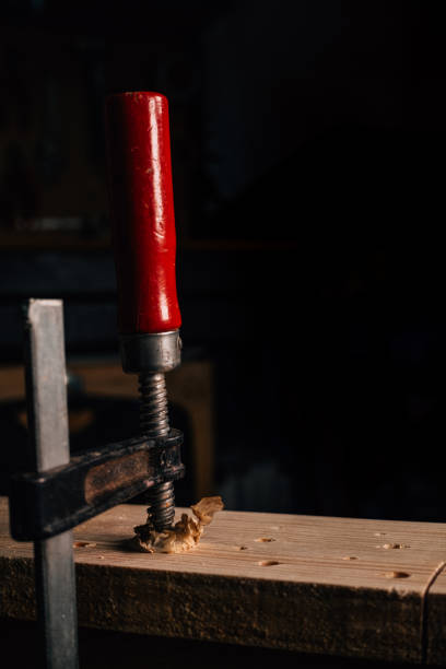 istock Wood clamp with red handle and dark background. 2177719794