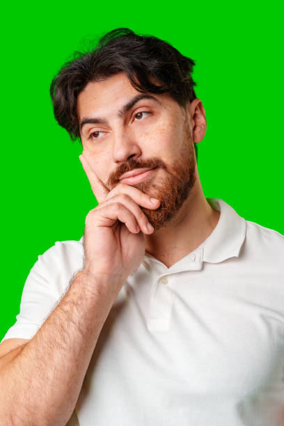 istock A man contemplates thoughtfully against a bright green background 2177720302