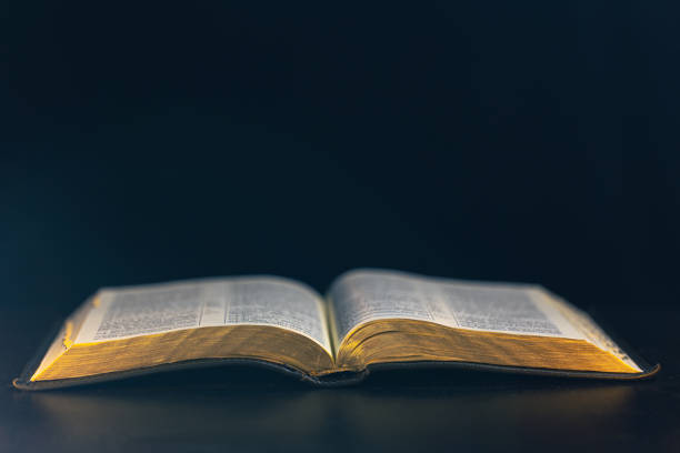 istock Open Bible on a black background. Religion concept. 2177720350