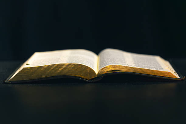 istock Open Bible on a black background. Religion concept. 2177720363