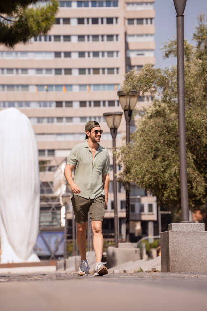istock Man smiling walking in the city during summertime 2177720798