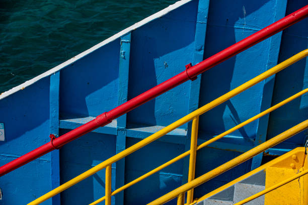 The ferry's blue painted hull and passenger handrails
