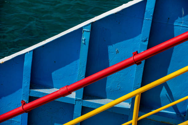 The ferry's blue painted hull and passenger handrails
