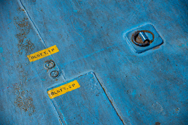 A blue painted floor of a ferry and a connecting hook