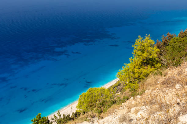 istock Summer landscape with a sandy beach next to a high cliff 2177722496