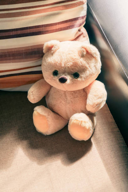 istock the bear doll on the couch with dramatic tone 2177722560