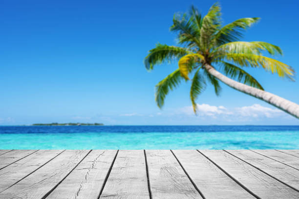 istock Empty wooden table top with beautiful tropical turquoise sea and coconut palm tree background 2177723204
