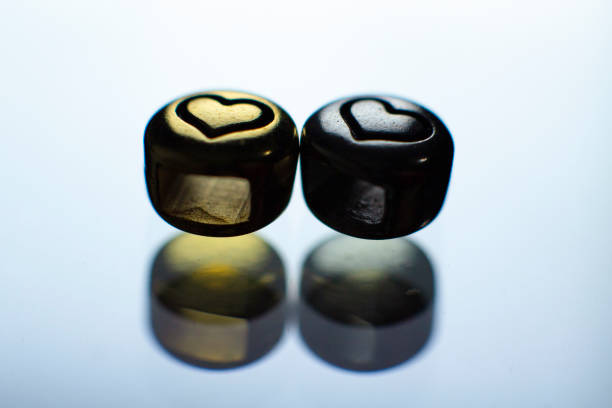 Gold and silver metal with heart design, reflection, couple
