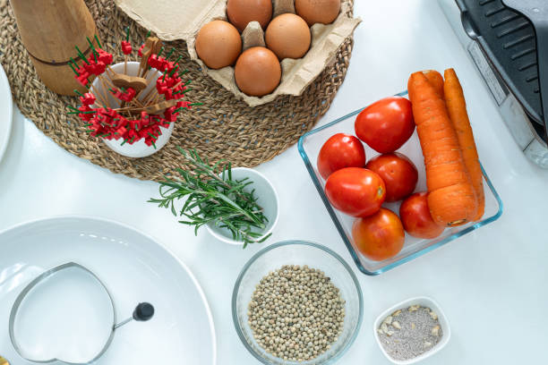 istock spices pepper in glass cup, vegetable,tomato,eggs and a whisk on the kitchen on white table. Flat lay. Concept of food preparation, kitchen on background. 2177723733
