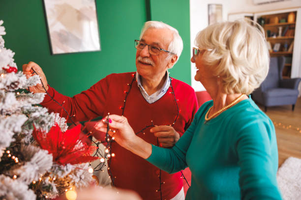 istock Senior couple having fun decorating Christmas tree 2177725235