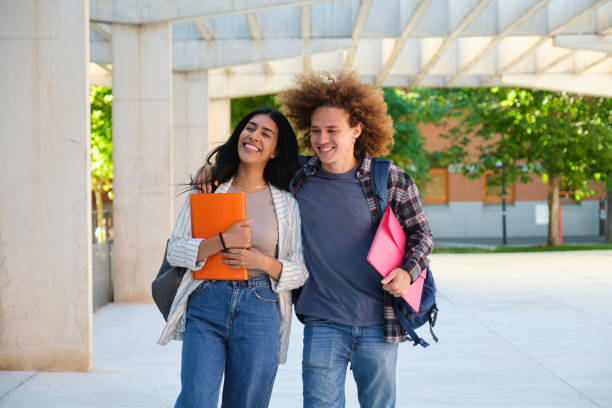 istock Two smiling students walking together at university campus 2177727717