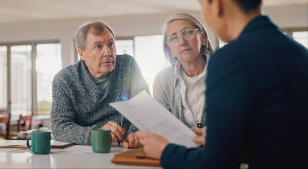 istock Conversation, documents and senior couple with financial advisor for retirement annuity saving account. Meeting, finance paperwork and elderly man and woman with investment banker for pension growth. 2177728590