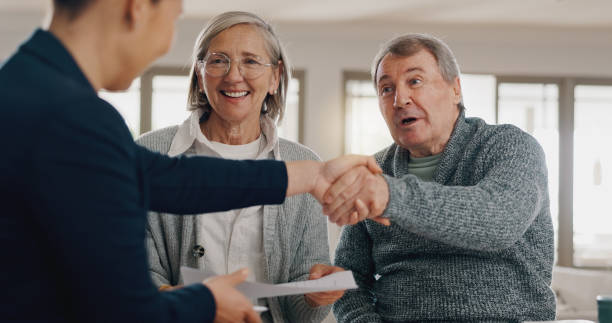 istock Financial advisor, handshake and senior couple with documents for insurance, saving and planning. Retirement, shaking hands and person with mature man and woman with paperwork, mortgage and pension 2177728592