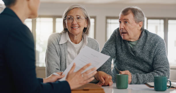 istock Discussion, documents and senior couple with financial advisor for retirement annuity saving account. Meeting, finance paperwork and elderly man and woman with investment banker for pension growth. 2177728594