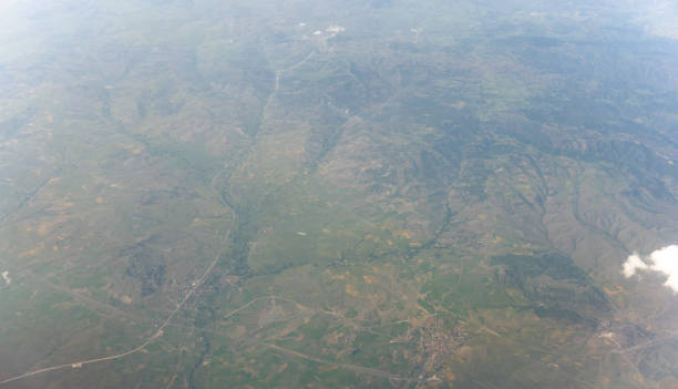 istock Aerial View from Jet Airliner: Clouds and Towns Below 2177730958