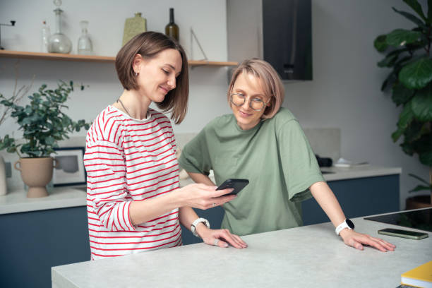 istock Two Women Sharing a Joyful Moment in a Modern Kitchen 2177731065